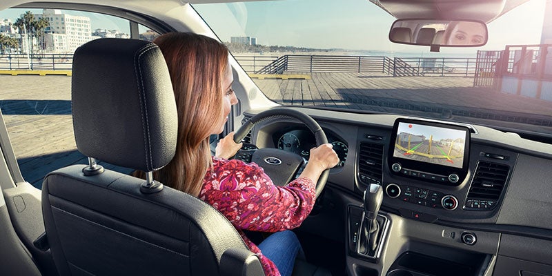 A lady is driving Ford Transit-Connect.
