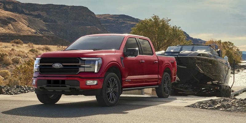  Ford F-150 is pulling another vehicle.