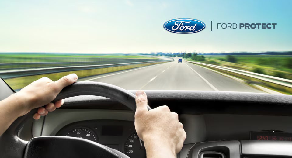 Ford vehicle is drivven on nice view road.