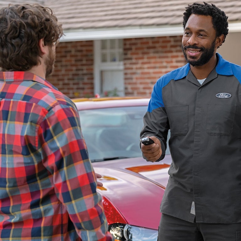 mobile service tech and customer Borgman Ford Mazda in Grandville MI